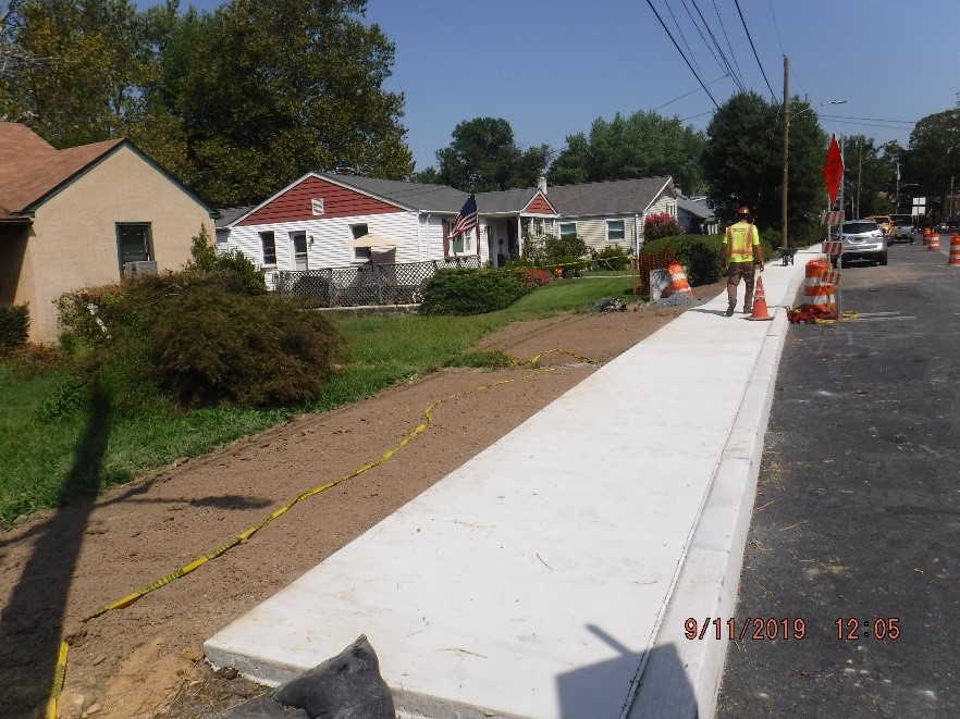 New concrete curb and sidewalk construction on the north side of Tyson Ave. east of Edgecomb Ave