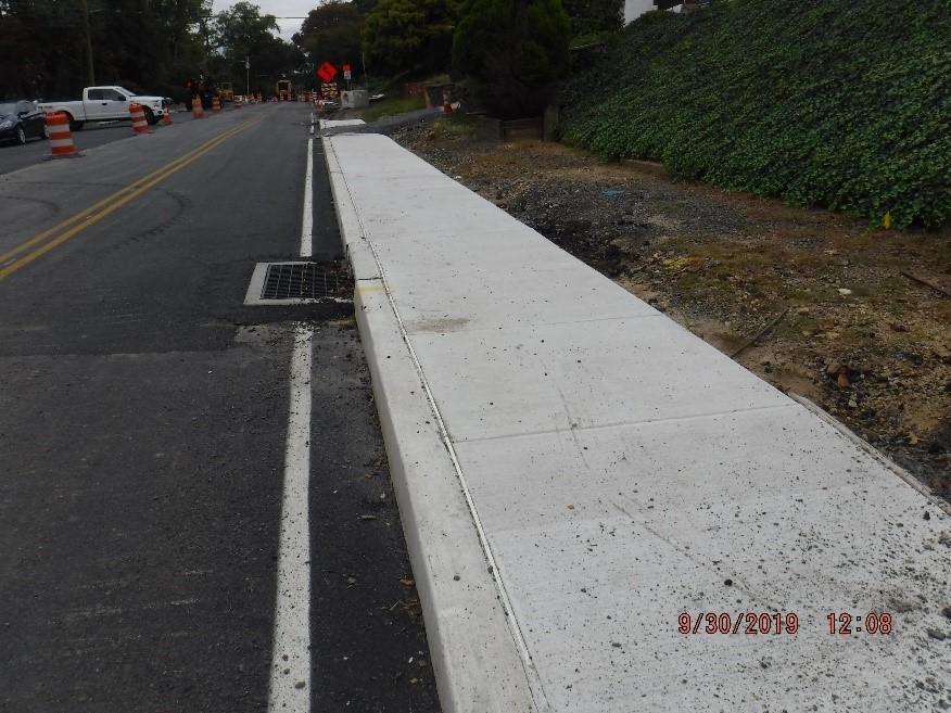 New concrete curb and sidewalk construction on the south side of tyson ave between bruce and custer avenues