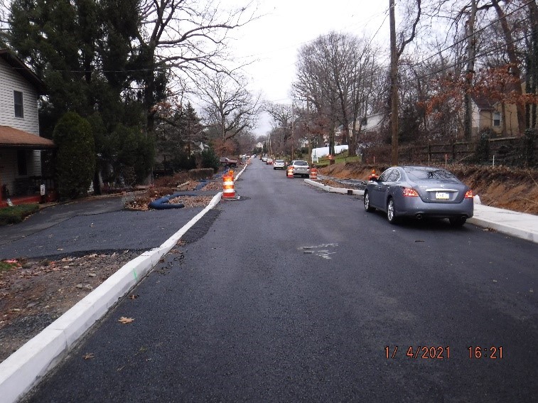 Roadway paving and new concrete curb and driveway adjustments on Edge Hill Road between Custer Avenue and Bradfield Road looking east