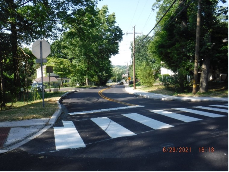 Final asphalt wearing course pavement  with line striping on Bradfield Road looking north.