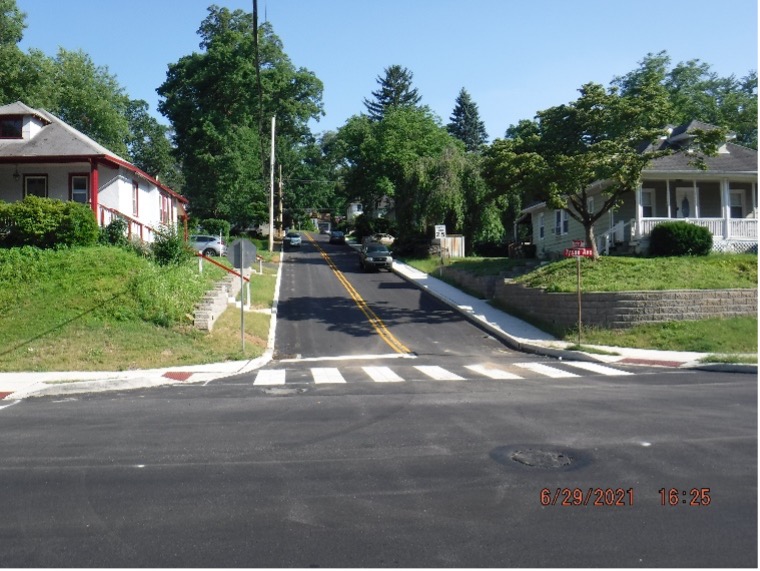 Final asphalt wearing course pavement with line striping on Custer Ave. looking south.