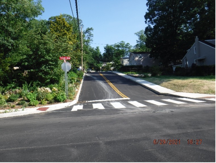 Final asphalt wearing course pavement with line striping on Edgecomb Ave. looking south.