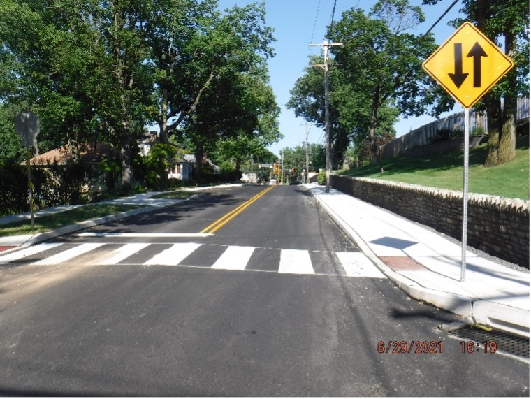 Final asphalt wearing course pavement with line striping on Edge Hill Road looking east towards Easton Road.