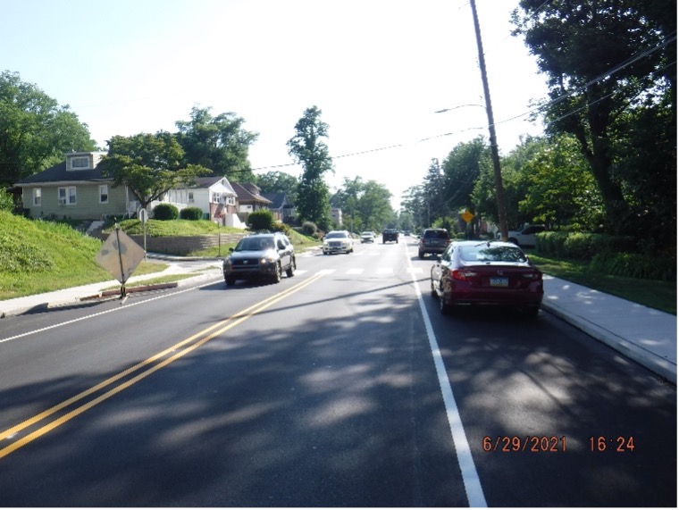 Final asphalt wearing course pavement with line striping on Tyson Ave. looking west towards Custer Ave.