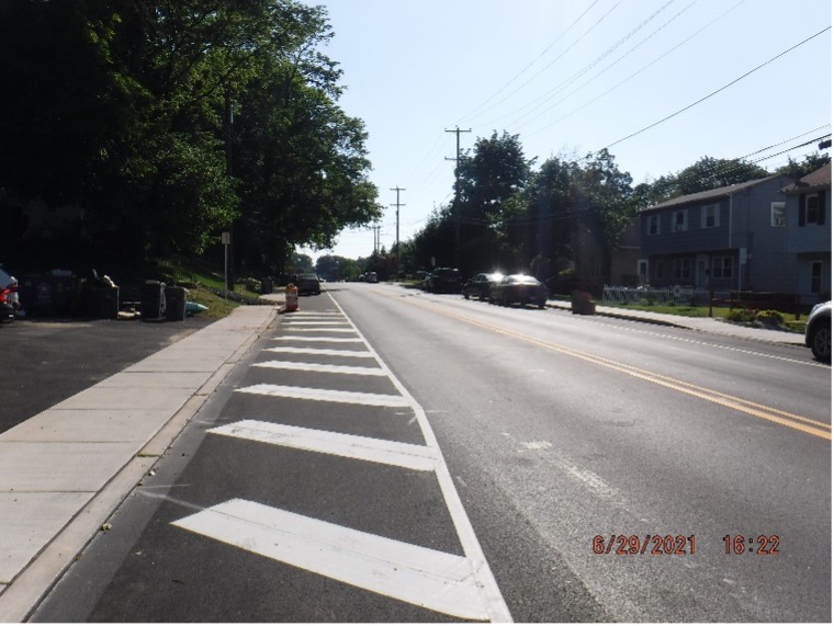 Final asphalt wearing course pavement with line striping on Tyson Ave. looking west between Easton Road and Bradfield Road.