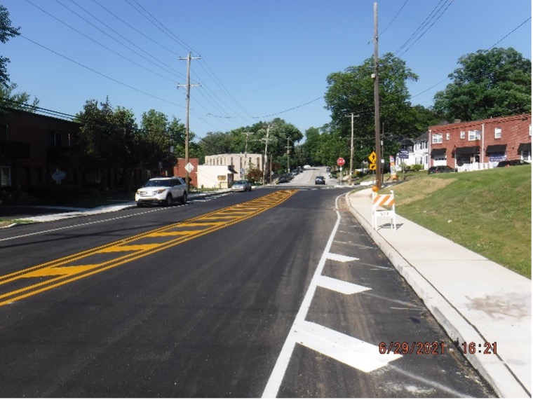 Final asphalt wearing course pavement with line striping on Tyson Ave. looking east between Easton Road and Bradfield Road.