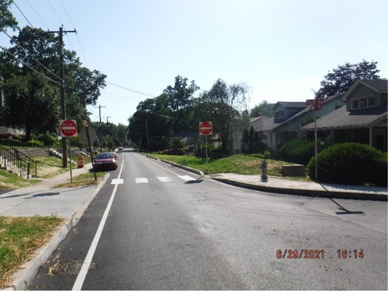 Final asphalt wearing course pavement with line striping and new signs on Edge Hill Road looking west from Custer Ave.