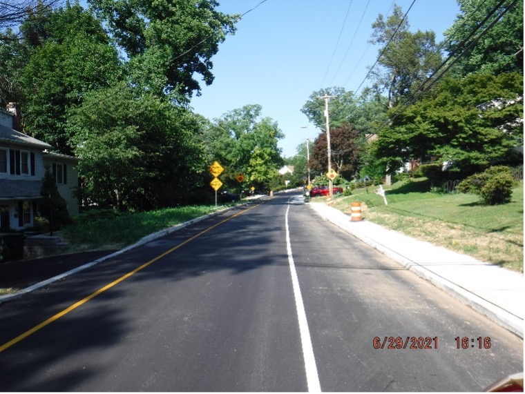 Final asphalt wearing course pavement with line striping on Edge Hill Road looking east between Custer Ave. and Bradfield Road.