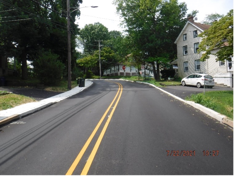 Image of final asphalt wearing course pavement with line striping on Bradfield Road looking south